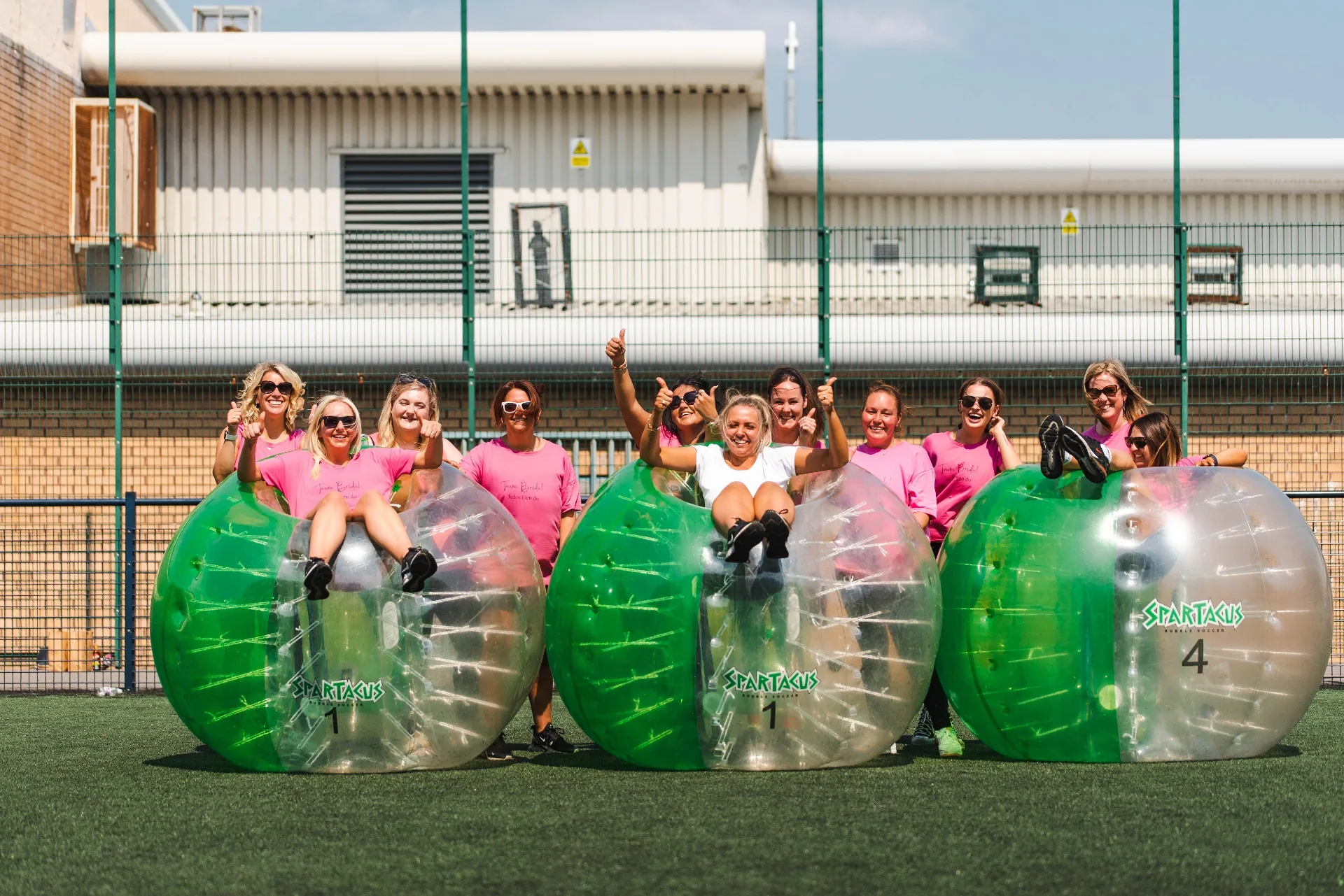 Hen party group posing with Spartacus bubble suits