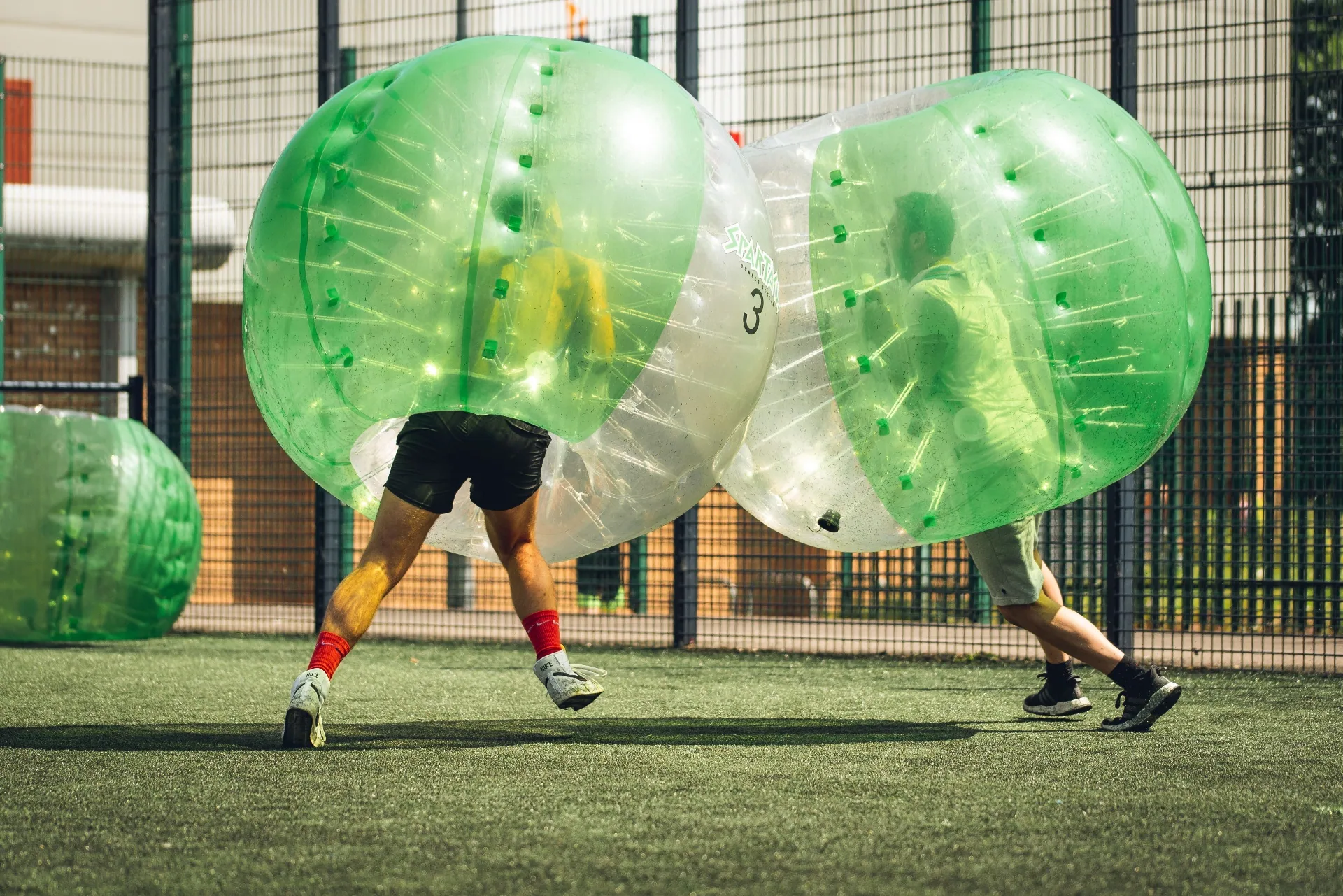 Two players clashing in bubble suits