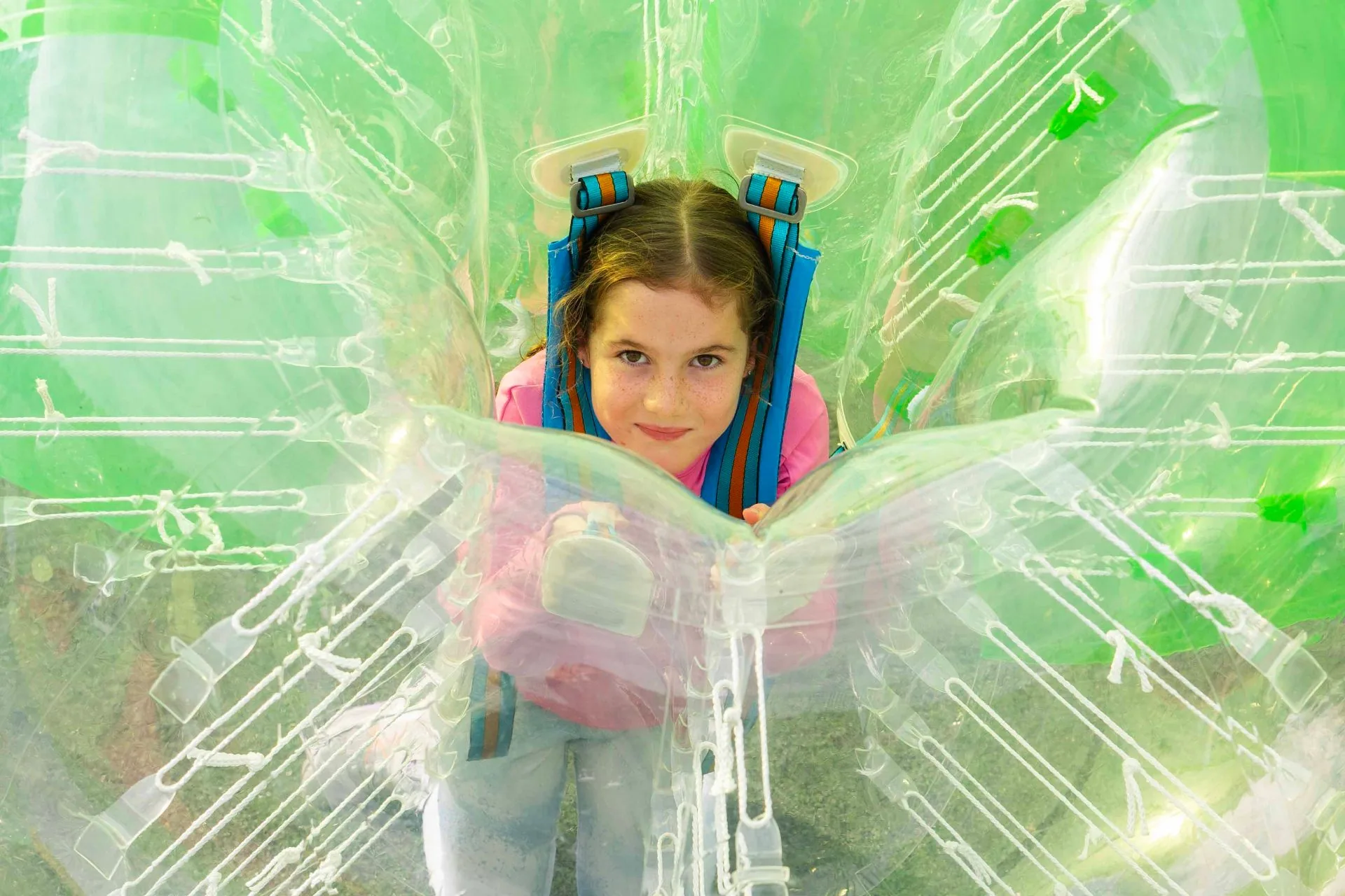 Girl smiling inside a Spartacus bubble suit